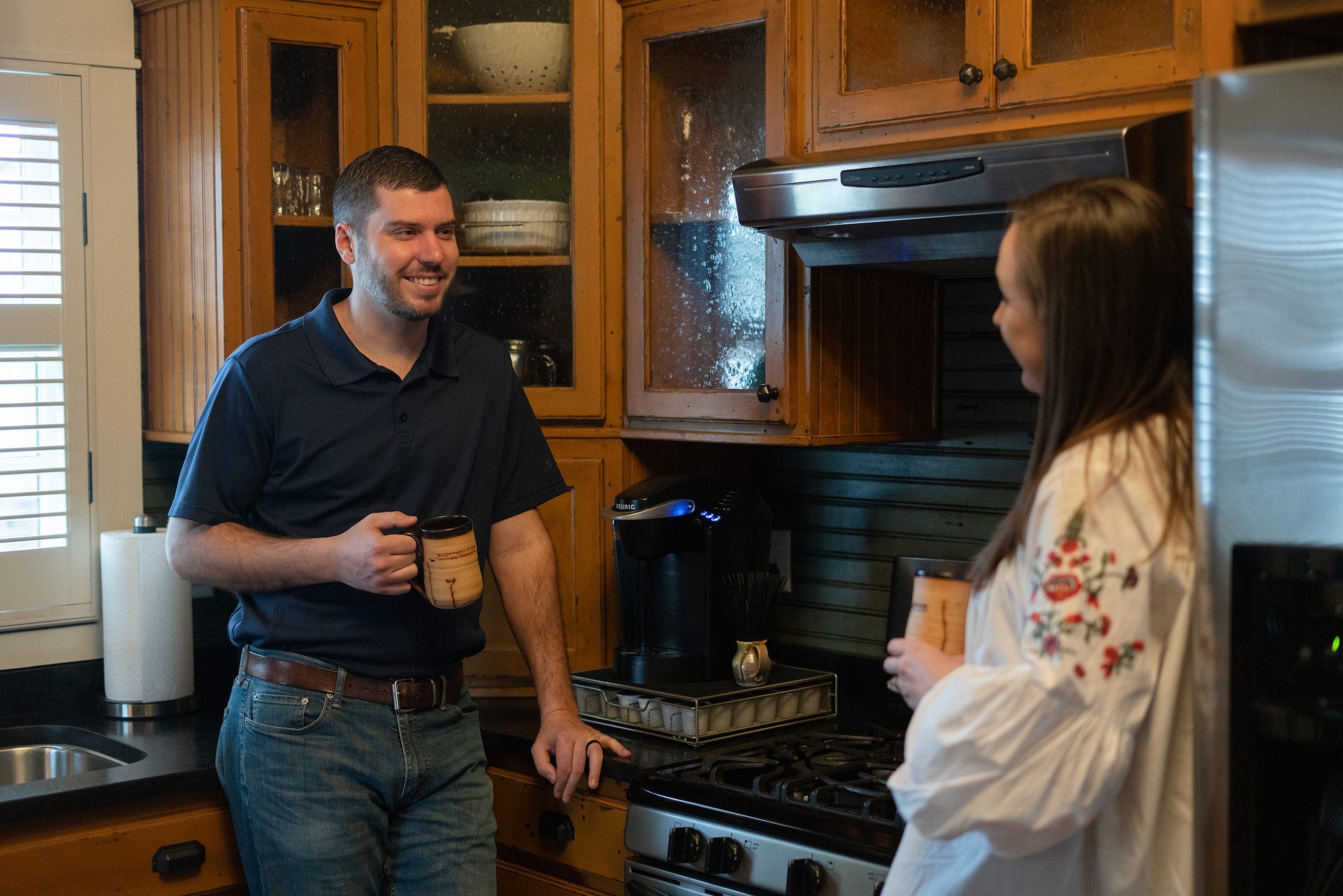 Couple sharing coffee in kitchen